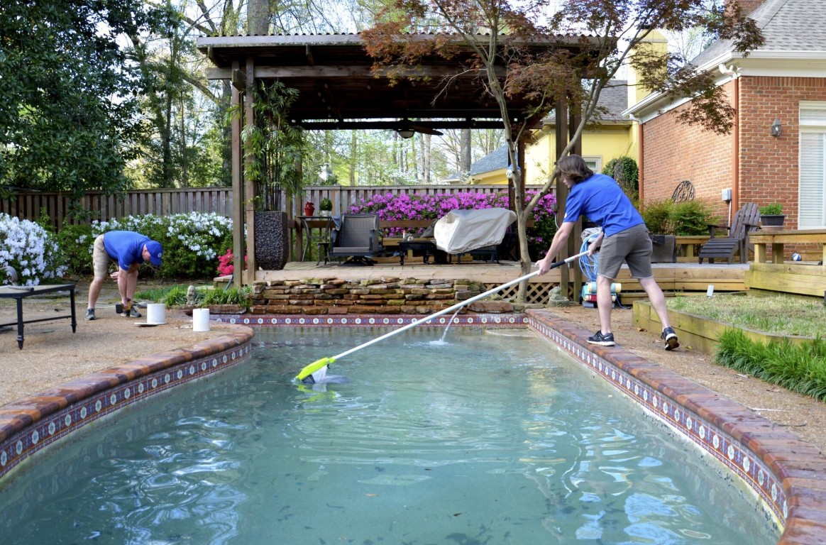 Professional pool cleaning technicians working in Castro Valley backyard